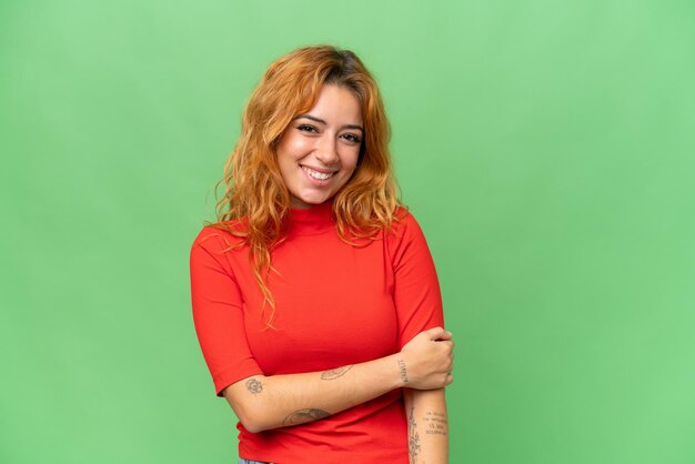 Young caucasian woman isolated on green screen chroma key background laughing