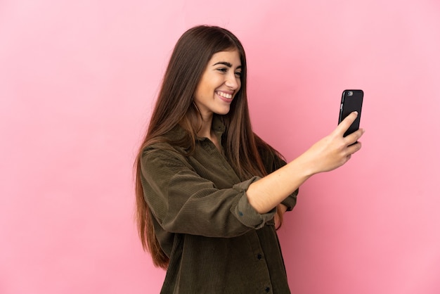 Young caucasian woman isolated making a selfie