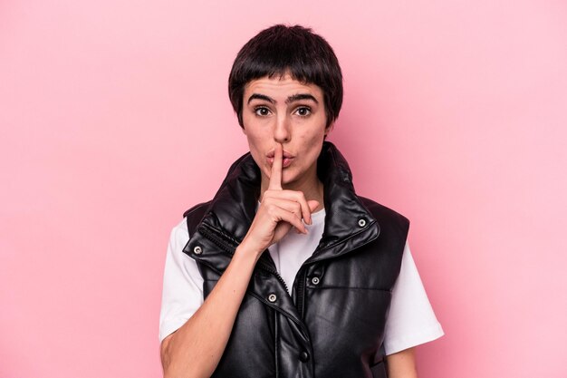 Young caucasian woman isolated on pink background keeping a secret or asking for silence.