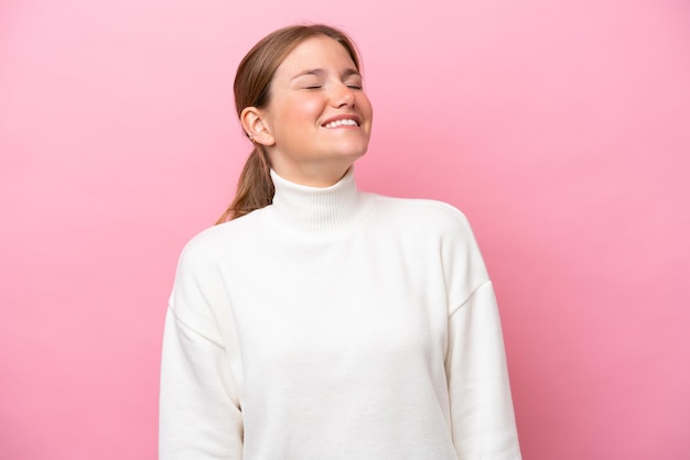 Young caucasian woman isolated on pink background laughing