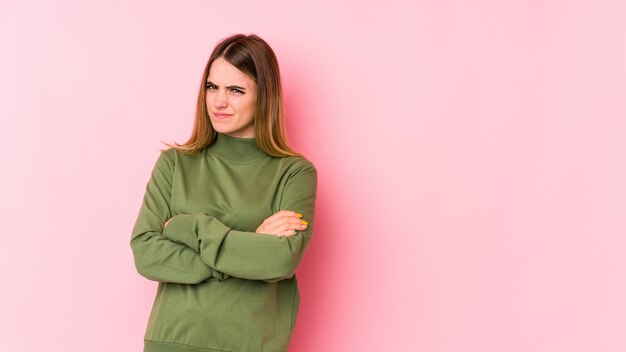 Young caucasian woman isolated on pink unhappy with sarcastic expression.