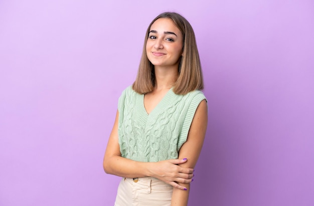 Young caucasian woman isolated on purple background laughing