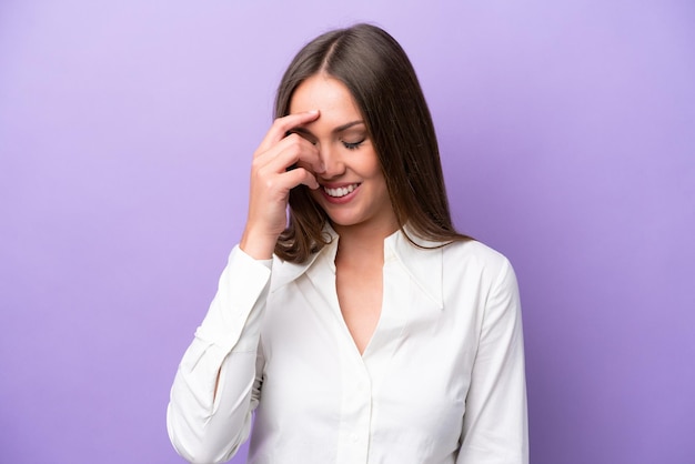 Young caucasian woman isolated on purple background laughing