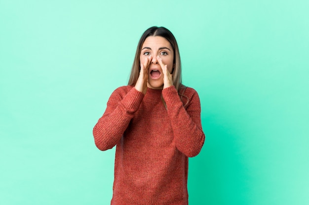 Young caucasian woman isolated shouting excited to front.