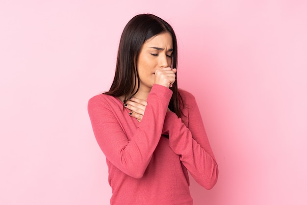 Young caucasian woman over isolated wall coughing a lot