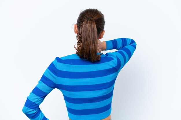 Young caucasian woman isolated on white background in back position and thinking