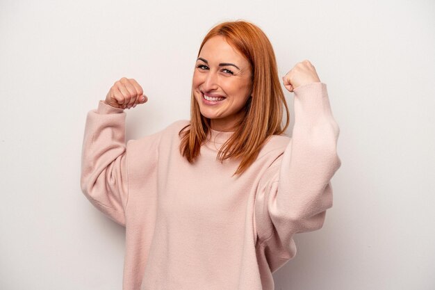 Young caucasian woman isolated on white background cheering carefree and excited Victory concept