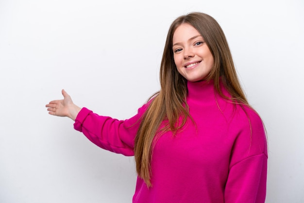 Young caucasian woman isolated on white background extending hands to the side for inviting to come