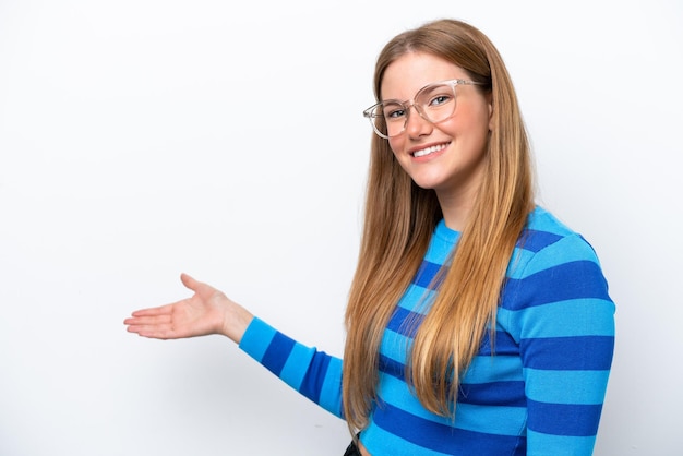 Young caucasian woman isolated on white background extending hands to the side for inviting to come