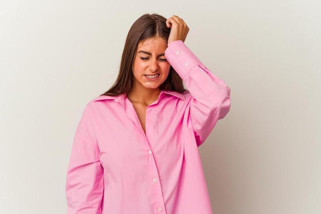 Young caucasian woman isolated on white background forgetting something slapping forehead with palm and closing eyes