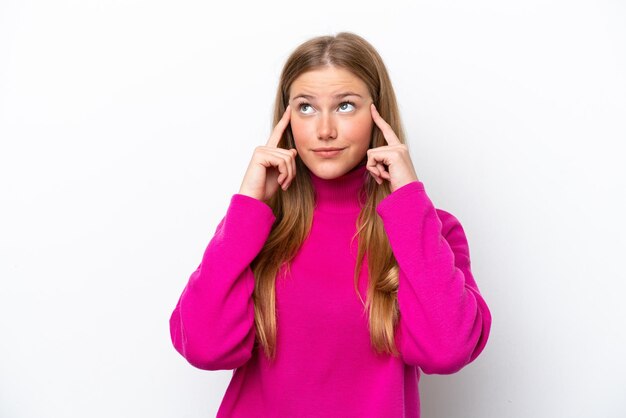 Young caucasian woman isolated on white background having doubts and thinking