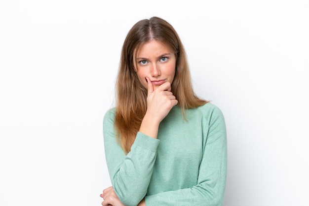 Young caucasian woman isolated on white background having doubts