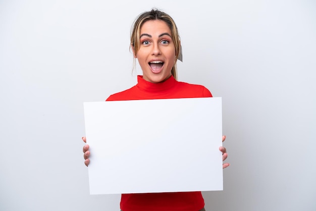 Young caucasian woman isolated on white background holding an empty placard with happy expression