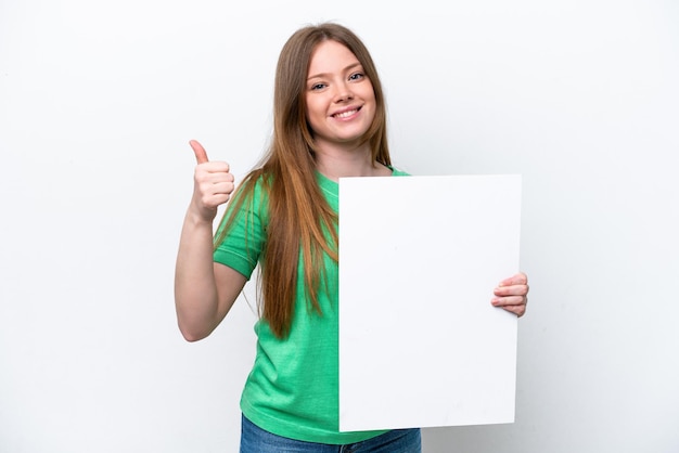 Young caucasian woman isolated on white background holding an empty placard with thumb up