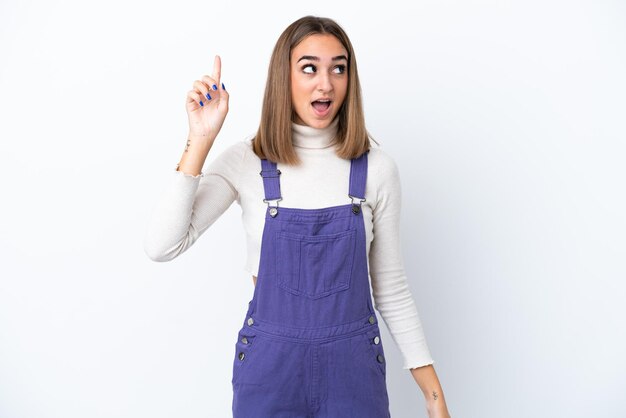 Young caucasian woman isolated on white background intending to realizes the solution while lifting a finger up