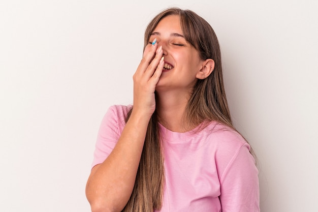 Young caucasian woman isolated on white background laughing happy, carefree, natural emotion.