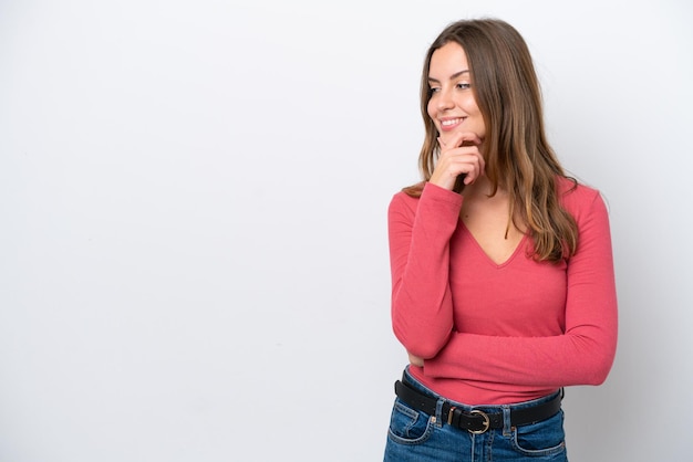 Young caucasian woman isolated on white background looking to the side and smiling