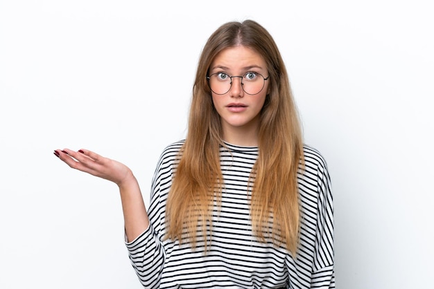 Young caucasian woman isolated on white background making doubts gesture