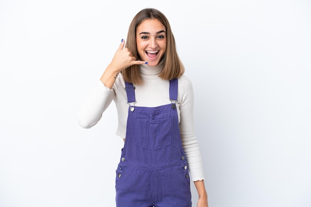 Young caucasian woman isolated on white background making phone gesture. Call me back sign