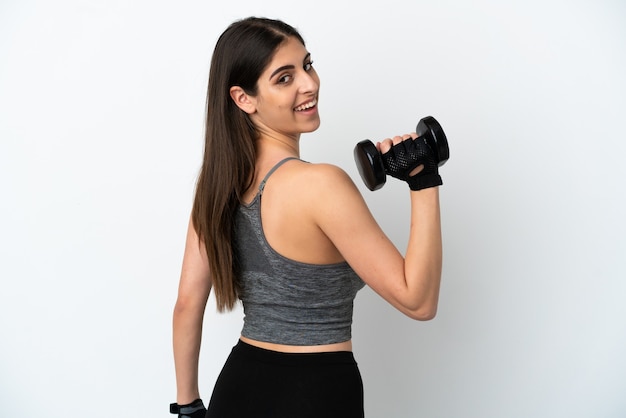 Young caucasian woman isolated on white background making weightlifting