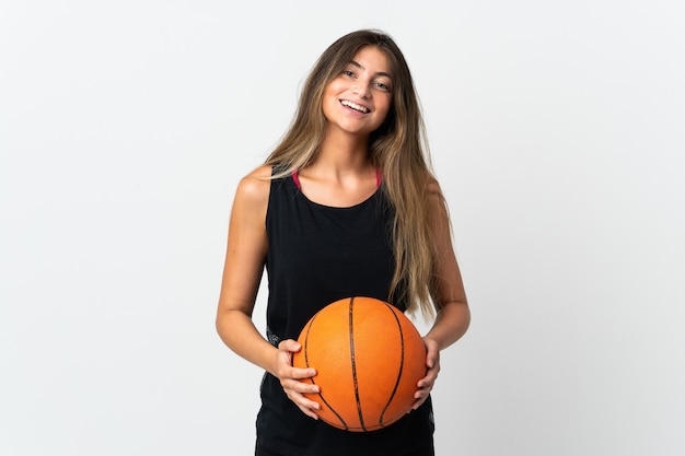 Young caucasian woman isolated on white background playing basketball