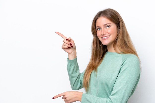 Young caucasian woman isolated on white background pointing finger to the side and presenting a product