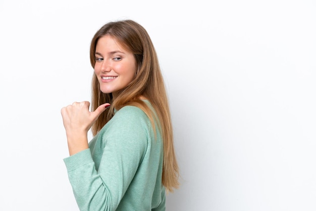 Young caucasian woman isolated on white background pointing to the side to present a product