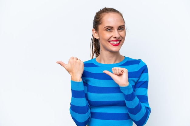 Young caucasian woman isolated on white background pointing to the side to present a product