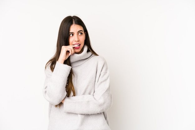 Young caucasian woman isolated on white background relaxed thinking about something looking at a copy space.