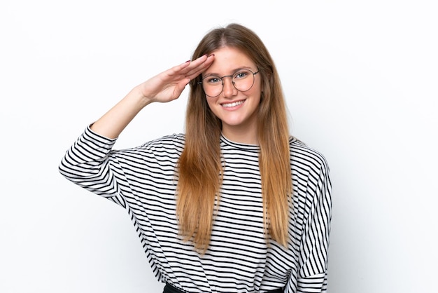 Young caucasian woman isolated on white background saluting with hand with happy expression