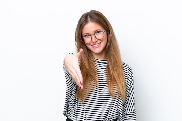 Young caucasian woman isolated on white background shaking hands for closing a good deal