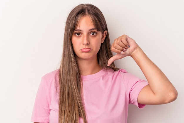 Young caucasian woman isolated on white background showing a dislike gesture, thumbs down. Disagreement concept.