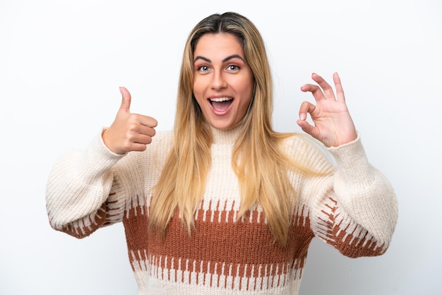 Young caucasian woman isolated on white background showing ok sign and thumb up gesture