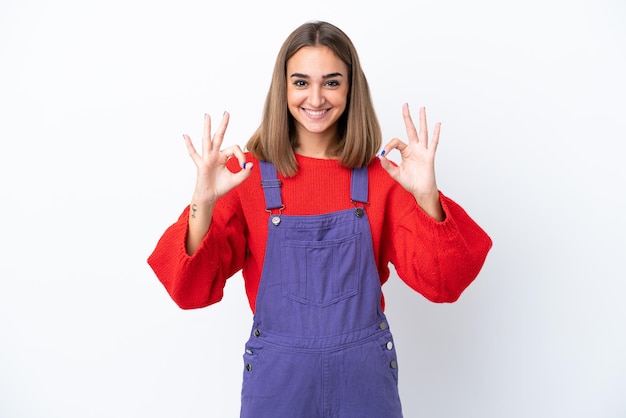 Young caucasian woman isolated on white background showing ok sign with two hands