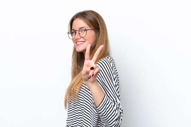 Young caucasian woman isolated on white background smiling and showing victory sign