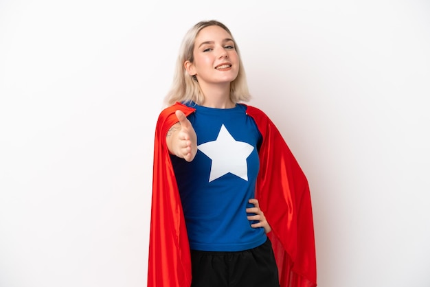 Young caucasian woman isolated on white background in superhero costume and making a deal