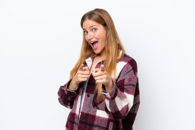 Young caucasian woman isolated on white background surprised and pointing front