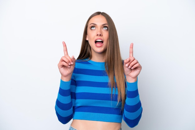 Young caucasian woman isolated on white background surprised and pointing up