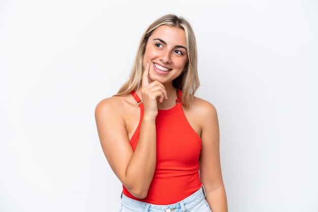 Young caucasian woman isolated on white background thinking an idea while looking up