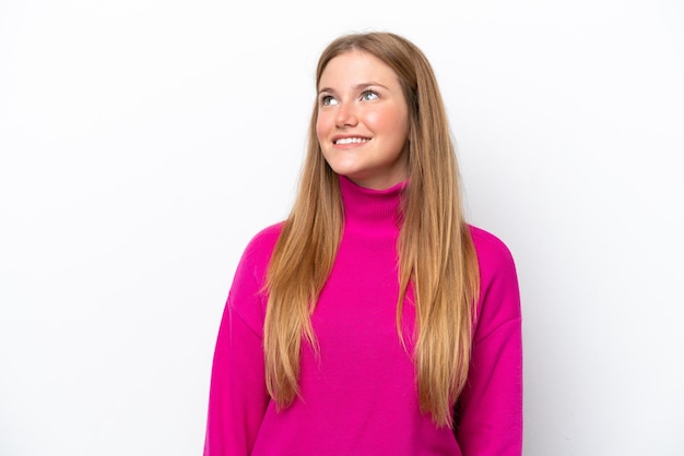 Young caucasian woman isolated on white background thinking an idea while looking up