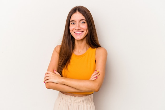 Young caucasian woman isolated on white background who feels confident, crossing arms with determination.