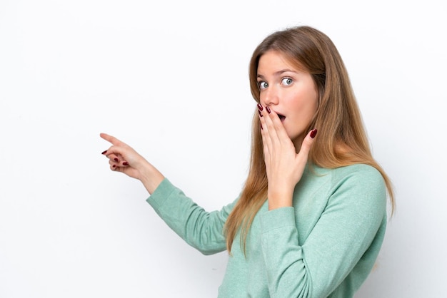 Young caucasian woman isolated on white background with surprise expression while pointing side