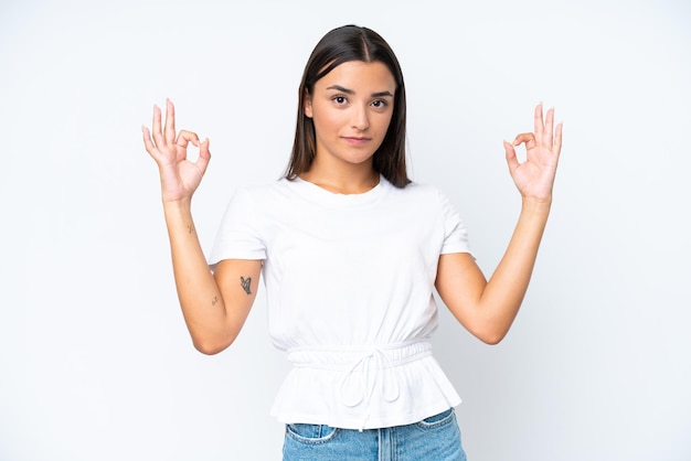 Young caucasian woman isolated on white background in zen pose