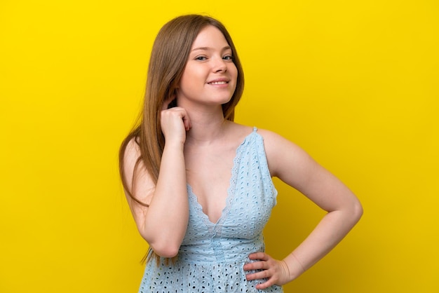 Young caucasian woman isolated on yellow background laughing