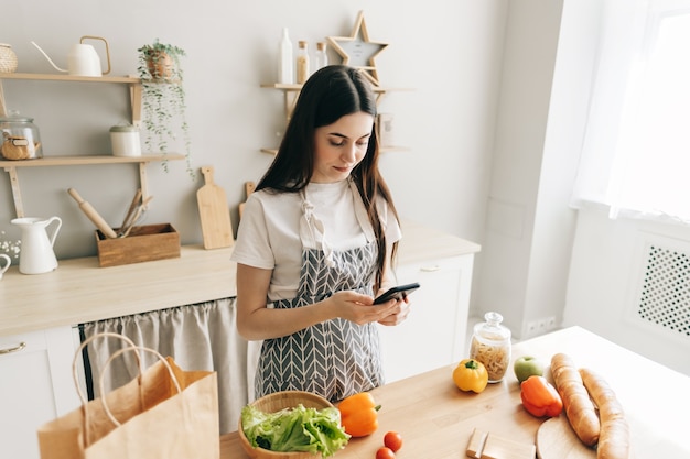 Young caucasian woman in the modern kitchen