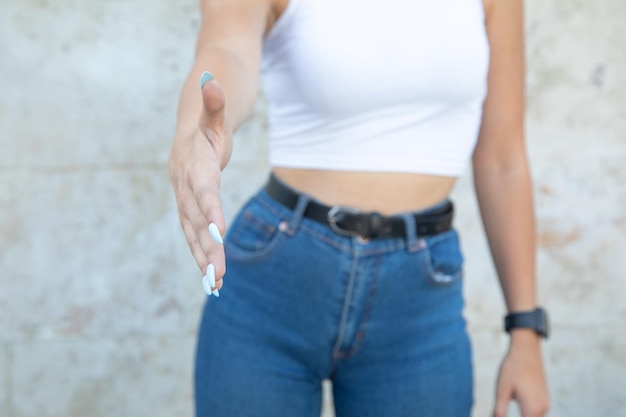 Young caucasian woman offering a handshake