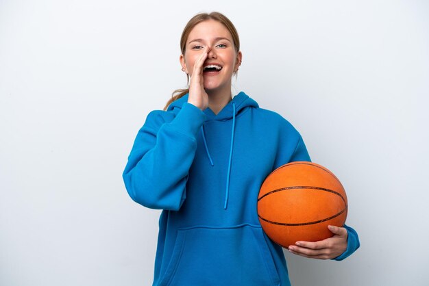 Young caucasian woman playing basketball isolated on white background shouting with mouth wide open