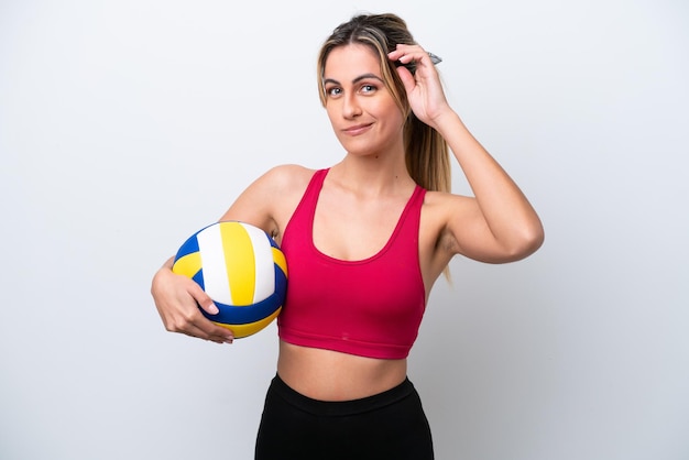 Young caucasian woman playing volleyball isolated on white background having doubts