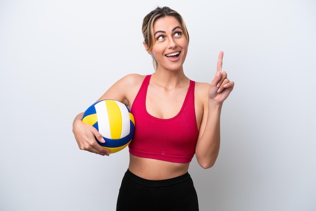 Young caucasian woman playing volleyball isolated on white background thinking an idea pointing the finger up