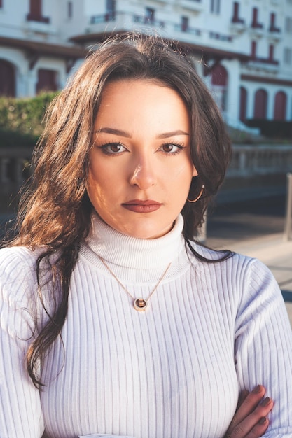 Young caucasian woman portrait standing in the middle of the street